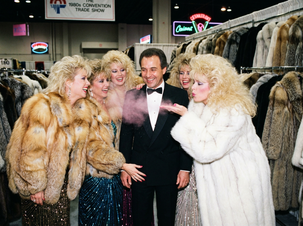 5_very_attractive_bleach_blonde_busty_glamorous_80s_models_with_enormous_breasts_smiling_and_laughin-nd_fluffiest_oversized_full_length_80s_fox_fur_coat-2.thumb.png.8a174ad6c23cd97b372e97a946ab92ba.png