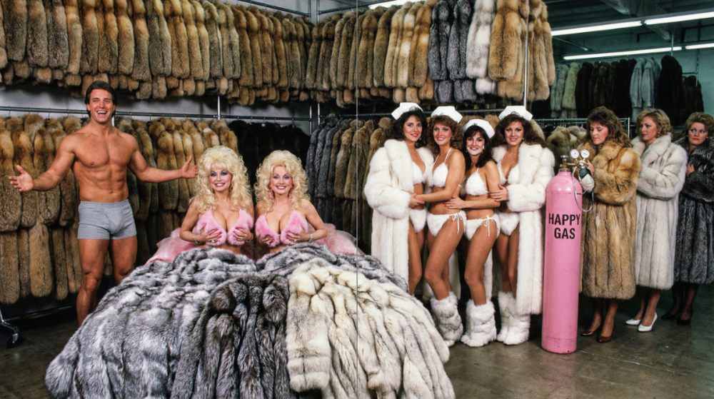 Retro_scene_80s_magazine_photoshoot_a_fur_warehouse_sale_with_hundreds_of_coats_for_a_high-end_80s_a-es_in_enormous_thick_oversized_fox_fur_coats..._The-4.thumb.png.995002fc08400333761d4fb746f10768.png