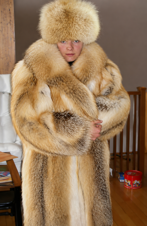 Luxurious fur fashion in a cozy setting.png